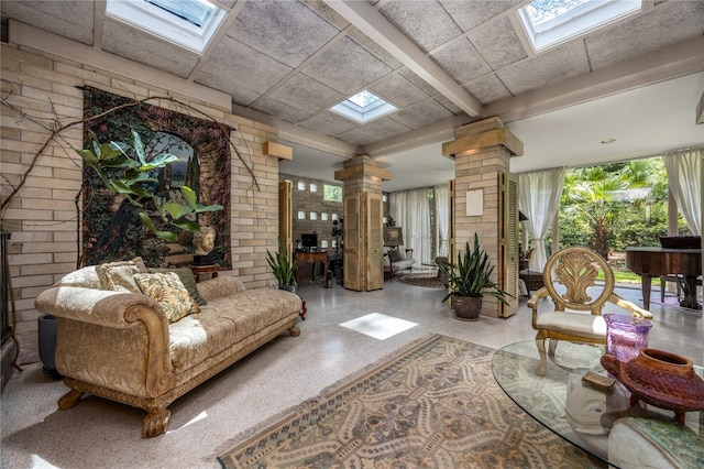 2010 NW 32nd Ter, Gainesville, FL 32605 - living room with a skylight, decorative columns, and speckle patterned floor