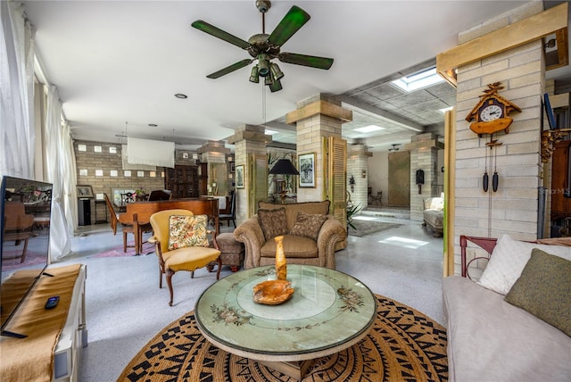 2010 NW 32nd Ter, Gainesville, FL 32605 - living area featuring a ceiling fan, a skylight, speckled floor, and ornate columns