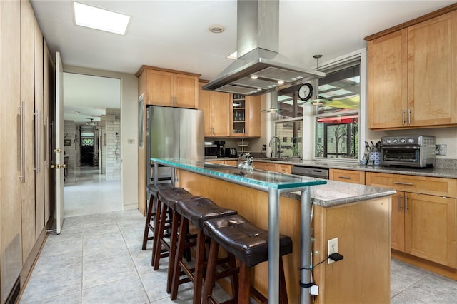2010 NW 32nd Ter, Gainesville, FL 32605 - kitchen featuring island range hood, a kitchen island with sink, stainless steel appliances, a breakfast bar, and light tile patterned flooring