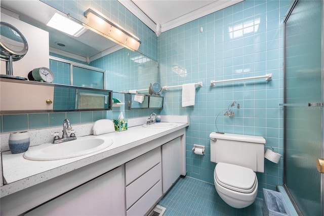 2010 NW 32nd Ter, Gainesville, FL 32605 - bathroom featuring tile walls, a shower stall, tile patterned floors, double vanity, and ornamental molding
