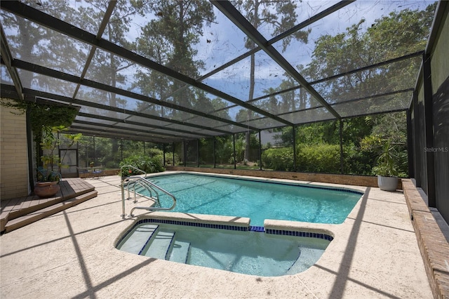 2010 NW 32nd Ter, Gainesville, FL 32605 - view of swimming pool featuring a patio, glass enclosure, and a pool with connected hot tub