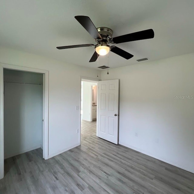 15433 SW 47th Avenue Rd, Ocala, FL 34473 - unfurnished bedroom with wood finished floors, a closet, and ceiling fan