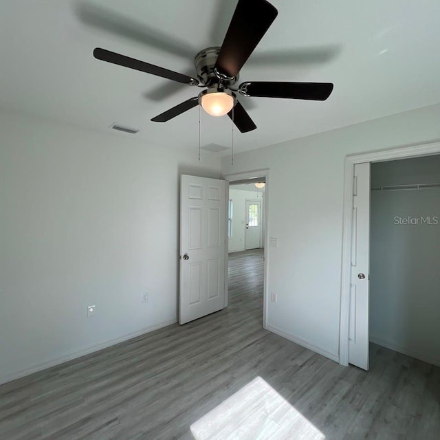15433 SW 47th Avenue Rd, Ocala, FL 34473 - unfurnished bedroom featuring wood finished floors, a ceiling fan, and a closet