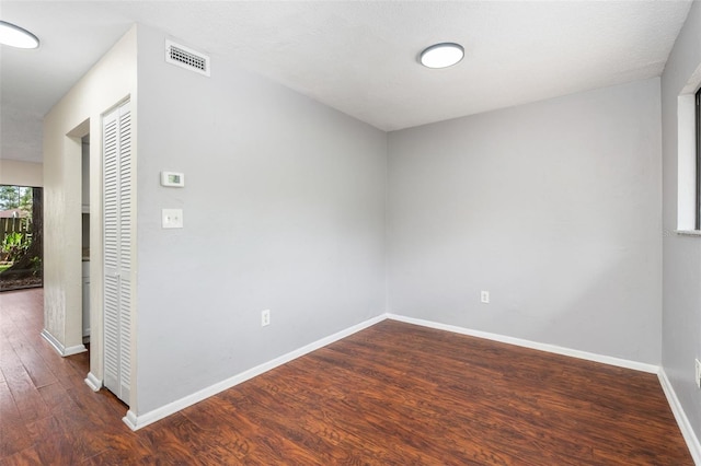 4325 NW 41st Pl Unit 6, Gainesville, FL 32606 - spare room featuring wood finished floors and baseboards