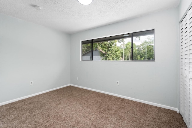 4325 NW 41st Pl Unit 6, Gainesville, FL 32606 - unfurnished room with carpet, a textured ceiling, and a smoke detector