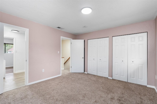 4325 NW 41st Pl Unit 6, Gainesville, FL 32606 - unfurnished bedroom with carpet and multiple closets