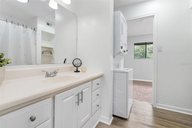 4325 NW 41st Pl Unit 6, Gainesville, FL 32606 - full bath with estacked washer and dryer, vanity, and wood finished floors