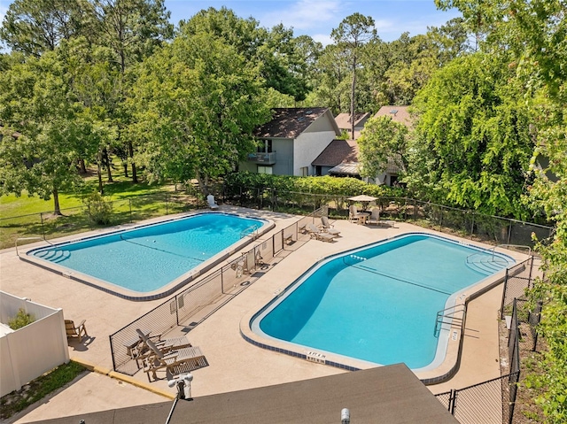 4325 NW 41st Pl Unit 6, Gainesville, FL 32606 - community pool featuring view of wooded area and a patio area