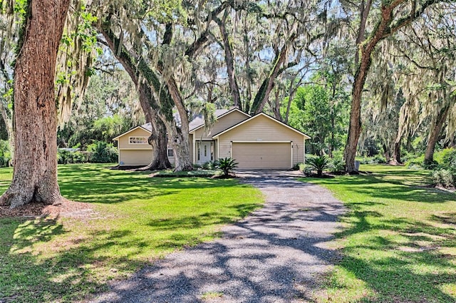 6505 SW 135th Pl, Archer, FL 32618 - view of front of house with gravel driveway, a garage, and a front lawn