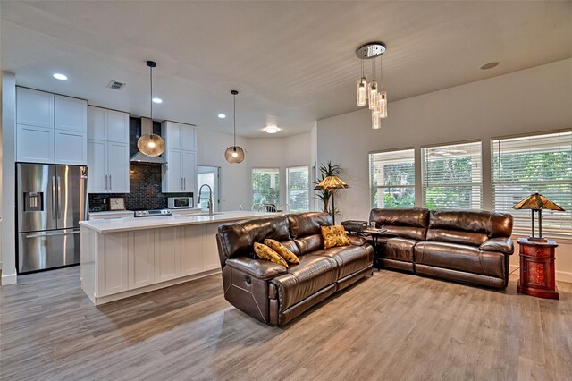 6505 SW 135th Pl, Archer, FL 32618 - living area featuring light wood finished floors, recessed lighting, and a chandelier