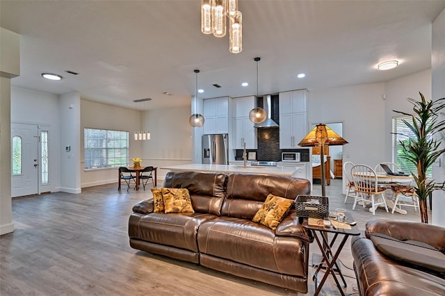 6505 SW 135th Pl, Archer, FL 32618 - living room featuring wood finished floors, recessed lighting, and a chandelier