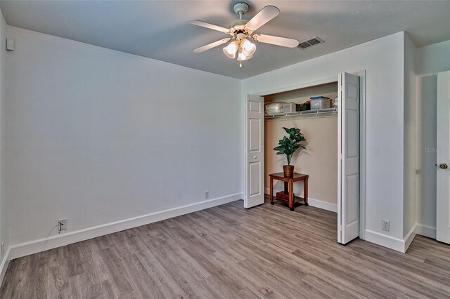 6505 SW 135th Pl, Archer, FL 32618 - unfurnished bedroom featuring wood finished floors, a ceiling fan, and a closet