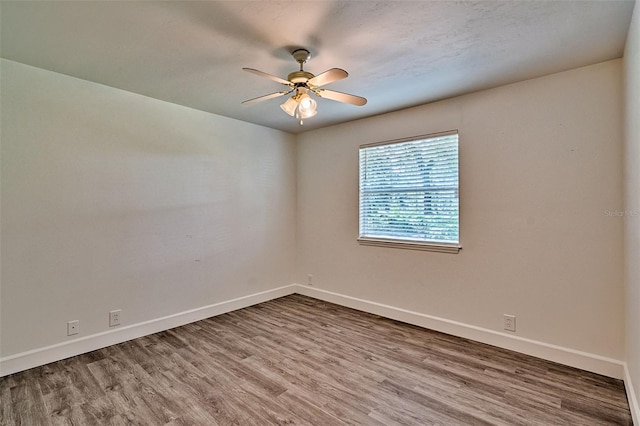 6505 SW 135th Pl, Archer, FL 32618 - spare room with a ceiling fan and wood finished floors