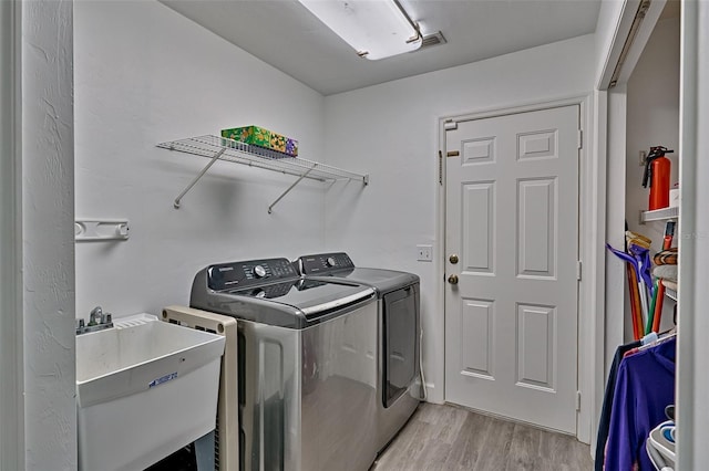 6505 SW 135th Pl, Archer, FL 32618 - washroom with independent washer and dryer and light wood-type flooring
