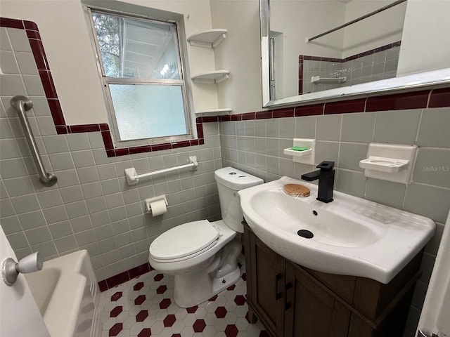 926 NW 24th Ave, Gainesville, FL 32609 - bathroom featuring tile walls, vanity, tile patterned flooring, and wainscoting