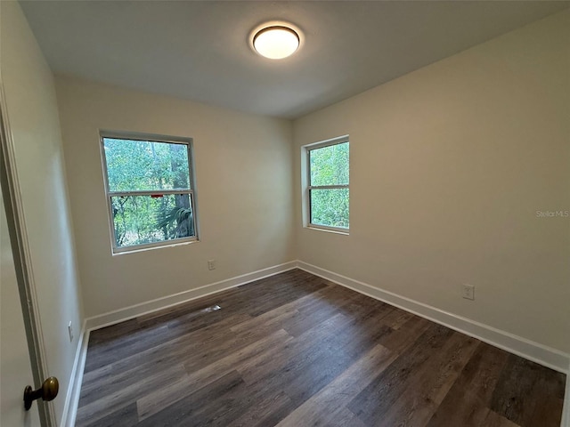 926 NW 24th Ave, Gainesville, FL 32609 - unfurnished room with baseboards and dark wood-style floors