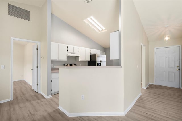 3846 NW 62nd Pl, Gainesville, FL 32653 - kitchen with stainless steel fridge with ice dispenser, light wood-style flooring, white cabinets, under cabinet range hood, and high vaulted ceiling