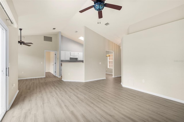 3846 NW 62nd Pl, Gainesville, FL 32653 - unfurnished living room with ceiling fan, light wood-style floors, and high vaulted ceiling