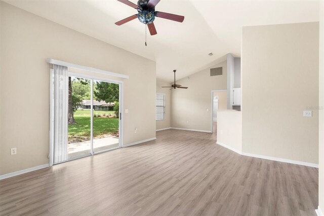 3846 NW 62nd Pl, Gainesville, FL 32653 - unfurnished living room featuring a ceiling fan, light wood-type flooring, and vaulted ceiling