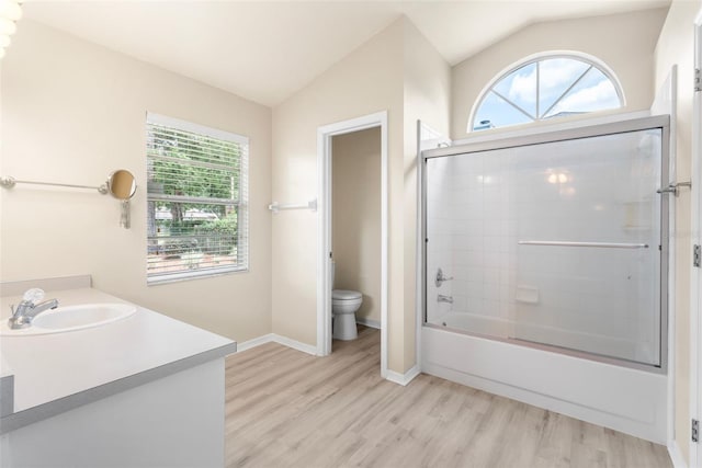 3846 NW 62nd Pl, Gainesville, FL 32653 - bathroom featuring plenty of natural light, wood finished floors, vaulted ceiling, vanity, and enclosed tub / shower combo