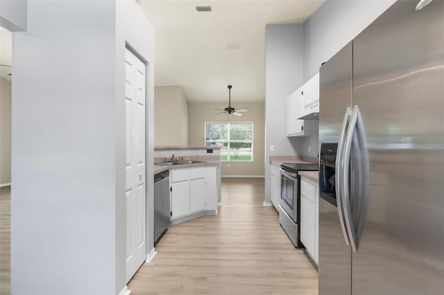 3846 NW 62nd Pl, Gainesville, FL 32653 - kitchen with stainless steel appliances, ceiling fan, light wood finished floors, white cabinetry, and under cabinet range hood