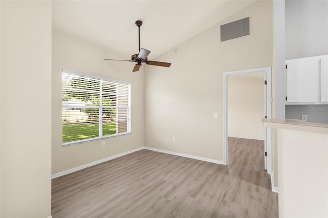 3846 NW 62nd Pl, Gainesville, FL 32653 - unfurnished room with light wood finished floors, a ceiling fan, and high vaulted ceiling