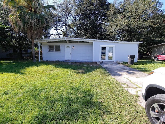 2904 NE 11th Ter, Gainesville, FL 32609 - view of front facade featuring french doors and a front lawn
