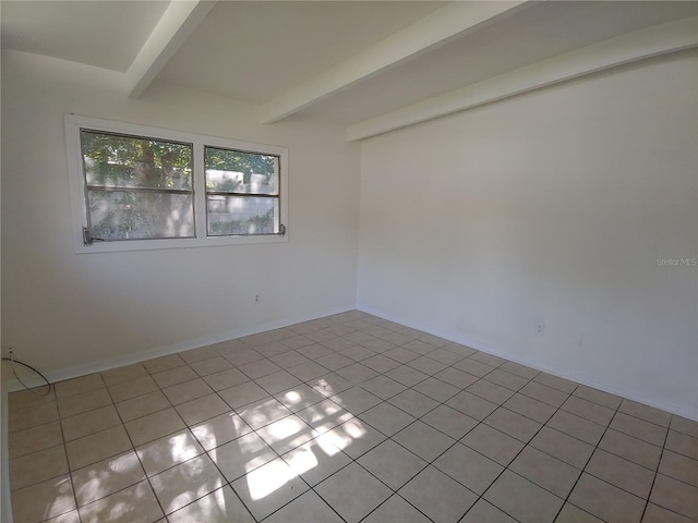 2904 NE 11th Ter, Gainesville, FL 32609 - unfurnished room featuring beam ceiling and light tile patterned flooring