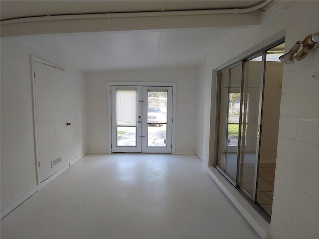 2904 NE 11th Ter, Gainesville, FL 32609 - unfurnished room with french doors and concrete floors