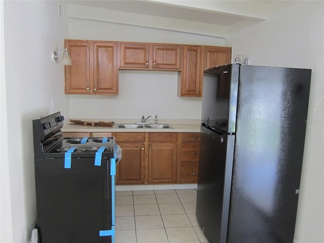 2904 NE 11th Ter, Gainesville, FL 32609 - kitchen with freestanding refrigerator, electric stove, light countertops, and brown cabinetry