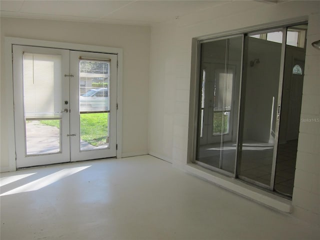 2904 NE 11th Ter, Gainesville, FL 32609 - empty room with french doors and finished concrete flooring