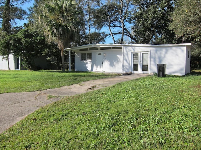 2904 NE 11th Ter, Gainesville, FL 32609 - view of front of house featuring a front yard and french doors
