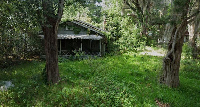 512 NW 9th Ave, Gainesville, FL 32601 - view of outdoor structure with a view of trees and a sunroom
