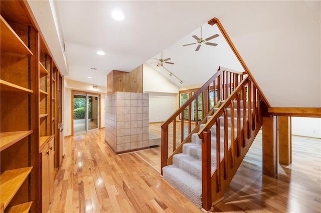1225 NW 23rd Ter, Gainesville, FL 32605 - stairs featuring ceiling fan, wood finished floors, vaulted ceiling, and recessed lighting