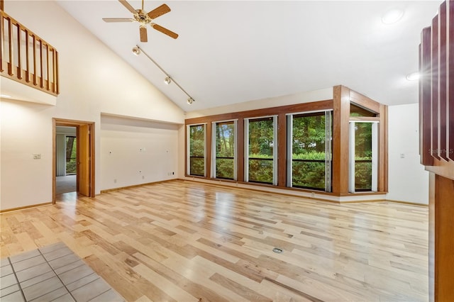 1225 NW 23rd Ter, Gainesville, FL 32605 - unfurnished living room with a ceiling fan, high vaulted ceiling, light wood finished floors, and track lighting