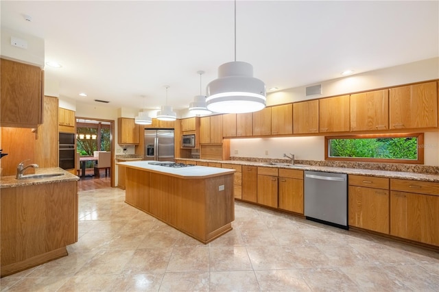 1225 NW 23rd Ter, Gainesville, FL 32605 - kitchen with stainless steel appliances, a center island, brown cabinetry, hanging light fixtures, and recessed lighting