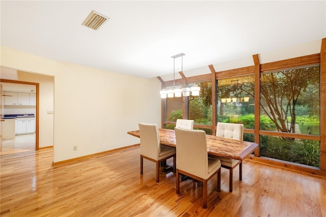 1225 NW 23rd Ter, Gainesville, FL 32605 - dining space with light wood-style floors and baseboards