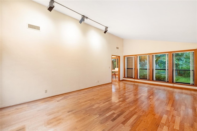 1225 NW 23rd Ter, Gainesville, FL 32605 - empty room with high vaulted ceiling, track lighting, and light wood-type flooring