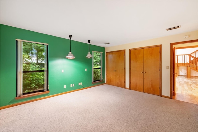 1225 NW 23rd Ter, Gainesville, FL 32605 - unfurnished bedroom featuring multiple closets and carpet floors