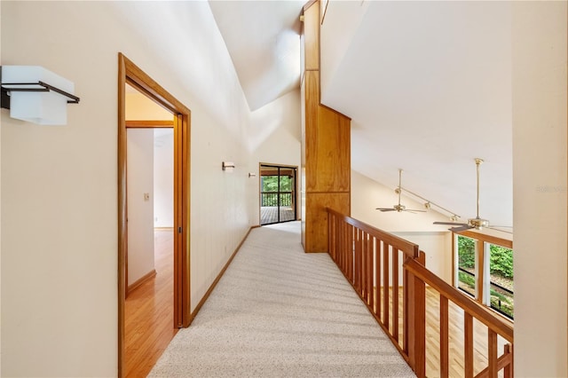 1225 NW 23rd Ter, Gainesville, FL 32605 - corridor featuring healthy amount of natural light, an upstairs landing, high vaulted ceiling, and light carpet