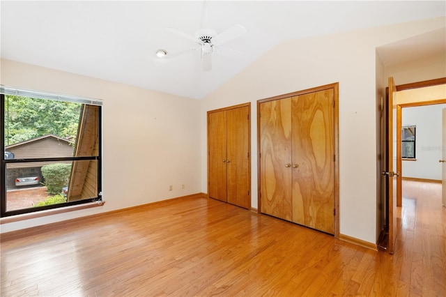1225 NW 23rd Ter, Gainesville, FL 32605 - unfurnished bedroom with two closets, light wood-type flooring, vaulted ceiling, and ceiling fan