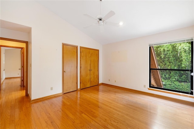 1225 NW 23rd Ter, Gainesville, FL 32605 - unfurnished bedroom with two closets, vaulted ceiling, light wood-type flooring, recessed lighting, and a ceiling fan