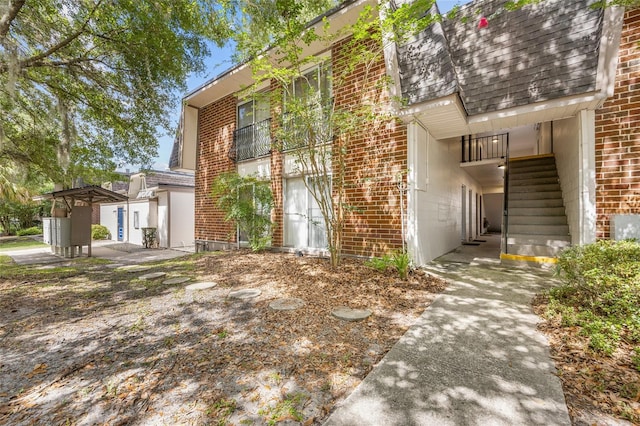 1700 SW 16th Ct Unit E9, Gainesville, FL 32608 - view of side of home featuring brick siding and stairway