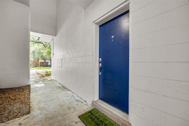 1700 SW 16th Ct Unit E9, Gainesville, FL 32608 - doorway to property with concrete block siding