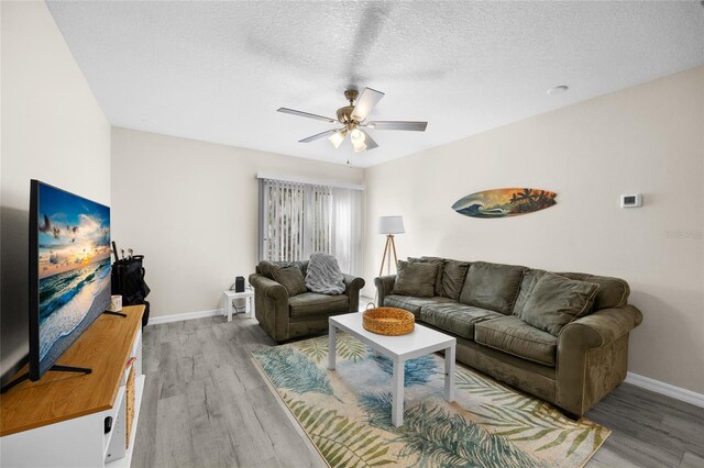 1700 SW 16th Ct Unit E9, Gainesville, FL 32608 - living room with ceiling fan, wood finished floors, and a textured ceiling