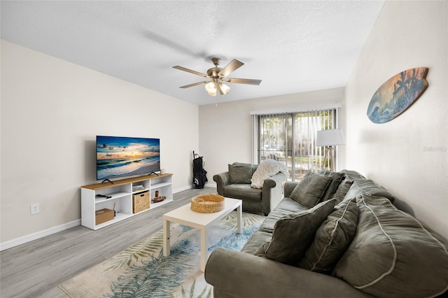 1700 SW 16th Ct Unit E9, Gainesville, FL 32608 - living room with wood finished floors, a ceiling fan, and a textured ceiling