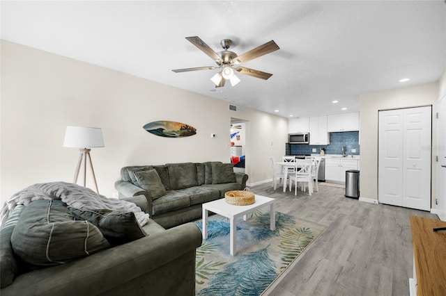 1700 SW 16th Ct Unit E9, Gainesville, FL 32608 - living room featuring light wood-type flooring, ceiling fan, and recessed lighting