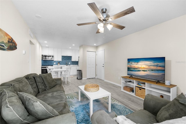 1700 SW 16th Ct Unit E9, Gainesville, FL 32608 - living room featuring light wood-style floors, ceiling fan, and recessed lighting