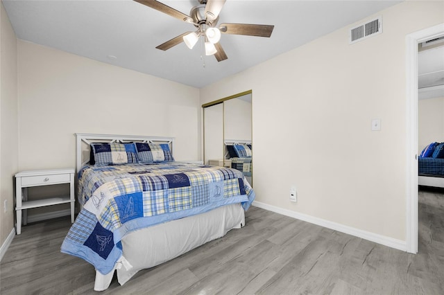 1700 SW 16th Ct Unit E9, Gainesville, FL 32608 - bedroom featuring wood finished floors, a closet, and ceiling fan
