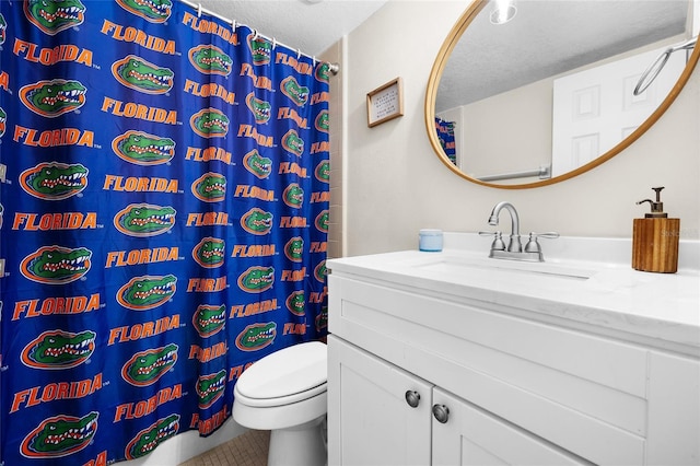 1700 SW 16th Ct Unit E9, Gainesville, FL 32608 - full bathroom featuring vanity, a textured ceiling, tile patterned flooring, and a shower with curtain